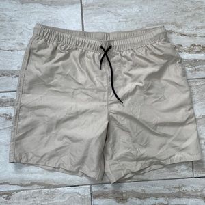 men beige swim trunks